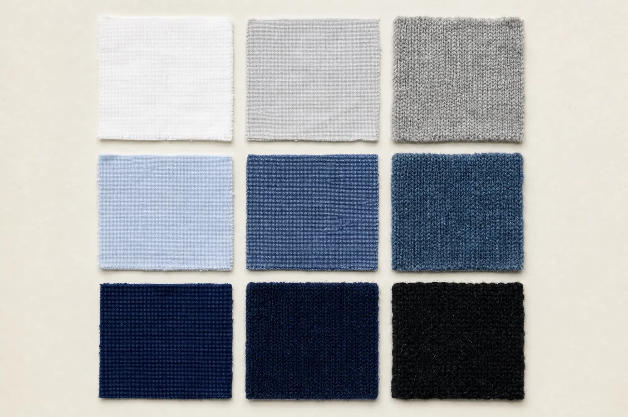 Nine fabric swatches in a three by three grid, graduating from white through pale grey and mid blue to deep indigo.